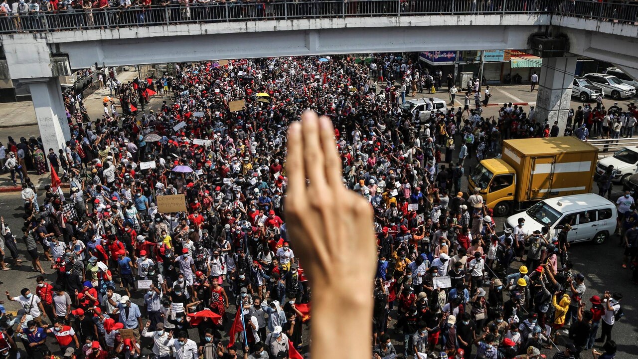 The protesters make the "three-fingers salute" and demand the release of Aung San Suu Kyi. (reuters.com)