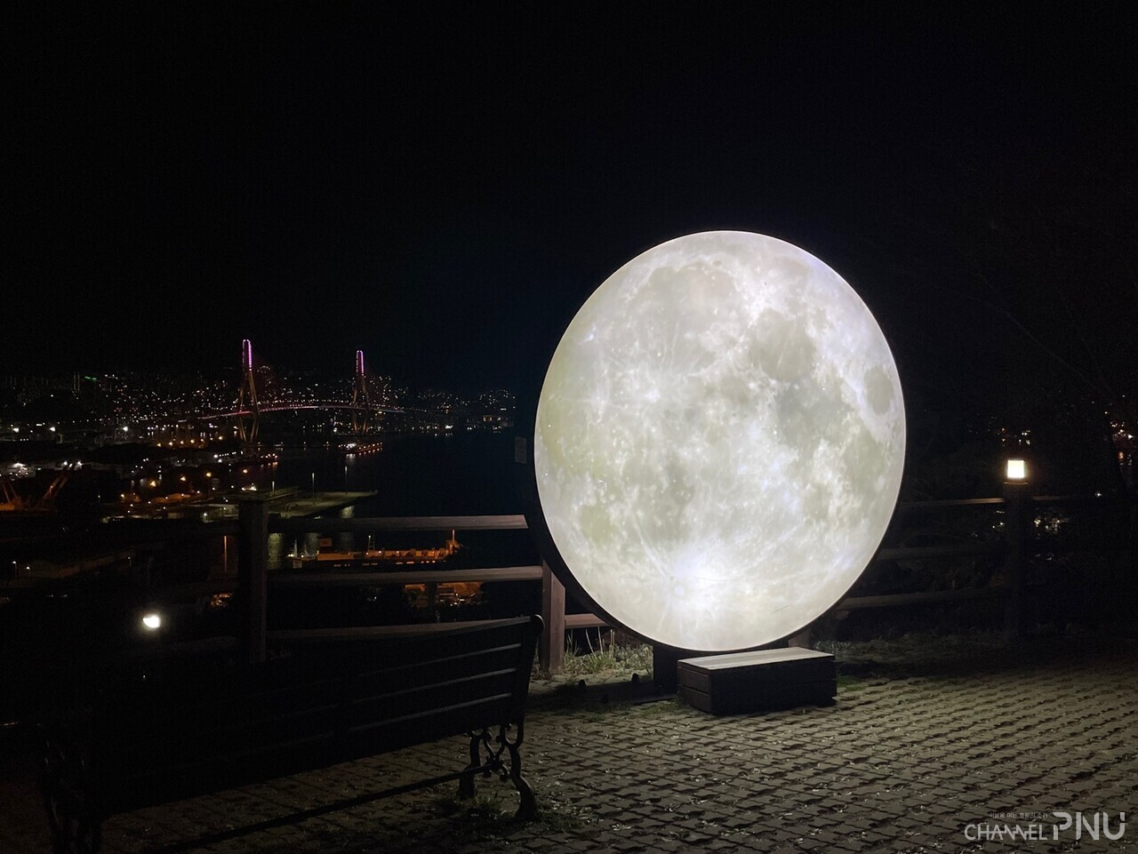On March 19th, Busan Port Bridge can be seen behind a full moon installation in the urban forest in Uam-dong. [Lim Chae-Kyung, reporter]
