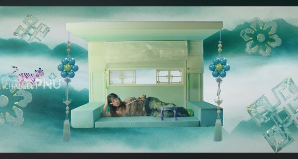 The music video for IVE's "HEYA," which was released in April, features traditional Korean fans, folding screens, and tobacco pipe, drawing the public's attention. [Source: Heya music video]